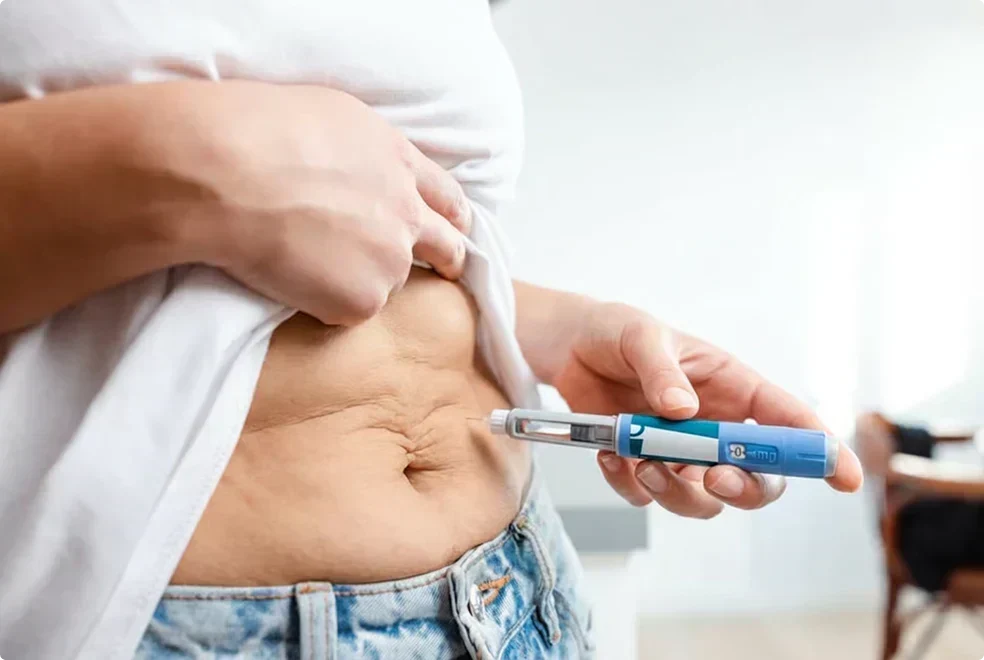 Person injecting a GLP-1 medication, illustrating muscle loss risk during weight loss